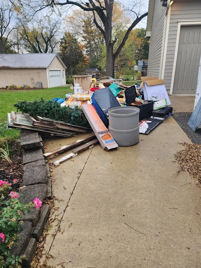 Dumpster being loaded with debris for 12 Yard Dumpster Rental in Lenoir